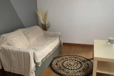 a small bedroom with a bed and a rug at Duplex à Monteux centre, 5 couchages distincts, LOCAL VELOS in Monteux