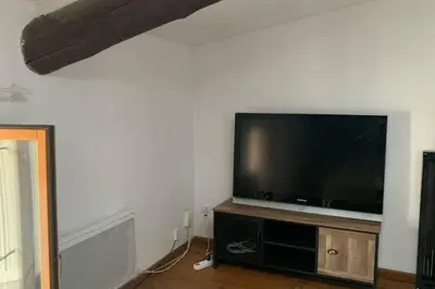 a living room with a flat screen tv on a wall at Duplex à Monteux centre, 5 couchages distincts, LOCAL VELOS in Monteux
