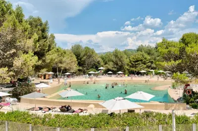 a large pool with people in it with umbrellas at Village Pont Royal en Provence - maeva Home - Appartement 2 pièces 6 personnes - Sélection MAE-8854 in Mallemort