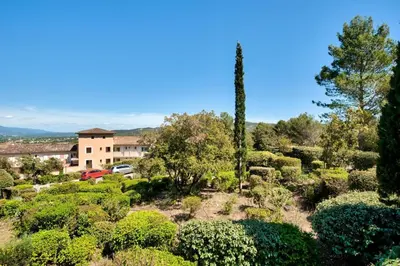 a garden with bushes and a building in the background at Village Pont Royal en Provence - maeva Home - Appartement 2 pièces 6 personnes - Sélection MAE-8854 in Mallemort