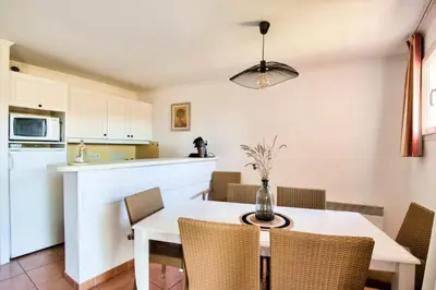 a kitchen and dining room with a table and chairs at Village Pont Royal en Provence - maeva Home - Appartement 2 pièces 6 personnes - Sélection MAE-8854 in Mallemort