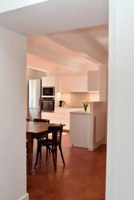 a kitchen and dining room with a table and refrigerator at L'Atelier Appartement au cœur du vignoble in Rognes