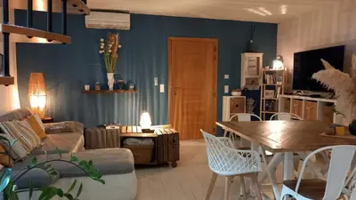 a living room with a couch and a table at Appartement duplex toit terrasse in Apt