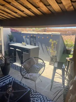 a patio with chairs and a table and a table and chairs at Appartement duplex toit terrasse in Apt
