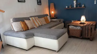 a living room with a couch and a table at Appartement duplex toit terrasse in Apt