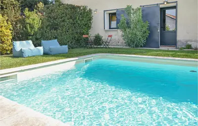 a swimming pool with blue water in front of a house at Stunning Home In Pernes-Les-Fontaines in Pernes-les-Fontaines