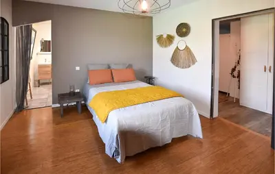 a bedroom with a bed with orange pillows on it at Stunning Home In Pernes-Les-Fontaines in Pernes-les-Fontaines