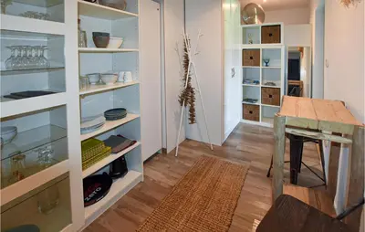 a dining room with a table and some shelves at Stunning Home In Pernes-Les-Fontaines in Pernes-les-Fontaines