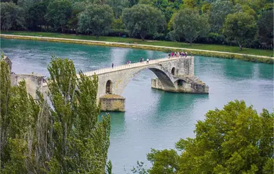 a group of people crossing a bridge over a river at Nice Apartment In Carpentras With Wifi in Carpentras