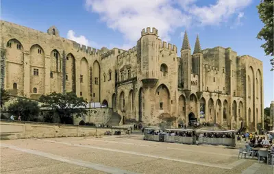 a large building with people standing outside of it at Nice Apartment In Carpentras With Wifi in Carpentras
