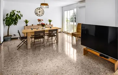 a living room with a table and a large television at Nice Apartment In Carpentras With Wifi in Carpentras