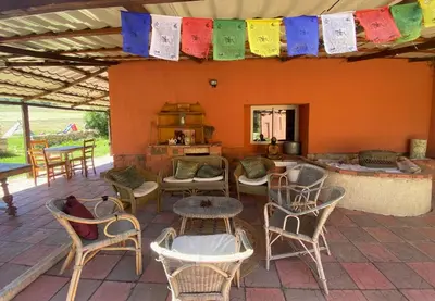 a patio with chairs and a table and a couch at Bergerie Joy, bienvenue entre Ciel & Terre in Saint-Christol