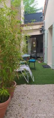 a patio with a table and chairs in a yard at la maison de josy in Aix-en-Provence
