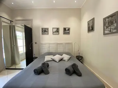 a bedroom with a large bed with two pillows at La Bastide des Rosiers in Mallemort