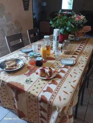 a table with a table cloth with food on it at Chambre d hôtes en Provence, au pied du Luberon, les Coquelicots in La Tour-dʼAigues