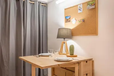 a table with a lamp and glasses on it at Studio Cardeurs in Aix-en-Provence