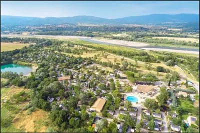 an aerial view of a resort with a river and trees at Camping Domaine des Iscles in La Roque-dʼAnthéron