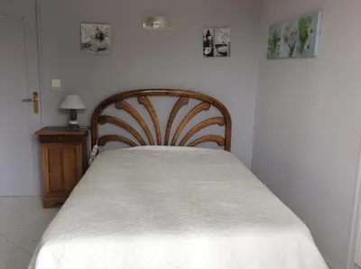 a bedroom with a bed with a white bedspread at VILLA MIREILLE CALME ARBOREE PISCINE SANS VIS A VIS SECURISEE in Morières-lès-Avignon