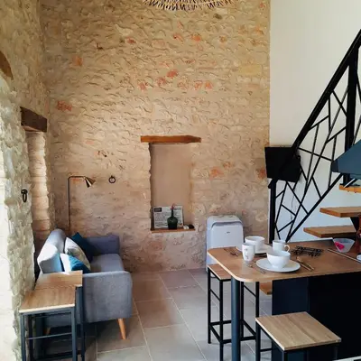 a living room with a couch and a table at Le Cabanon des Lavandes entre Mont Ventoux et Luberon in Sault-de-Vaucluse