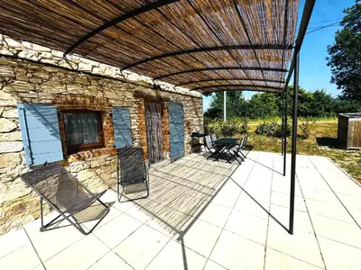 a patio with chairs and a wooden pergola at Le Cabanon des Lavandes entre Mont Ventoux et Luberon in Sault-de-Vaucluse