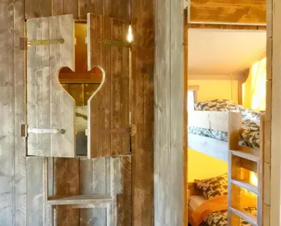 a door with a heart on it in a room with bunk beds at La Grisonne - Chalet3 in Revest-du-Bion