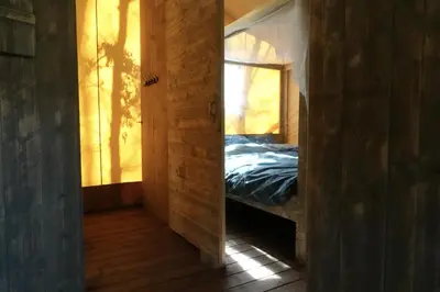 a mirror in a room with a bed in it at La Grisonne - Chalet3 in Revest-du-Bion