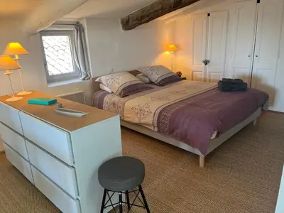 a bedroom with a bed with a dresser and a stool at Magic views in paradise in Joucas