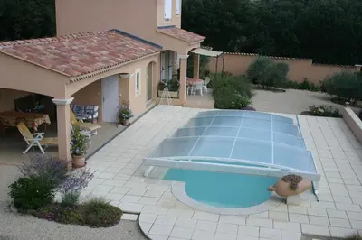 a swimming pool in a yard with a house at Gîte Les Hauts Sauviers avec piscine et sauna in Bédoin