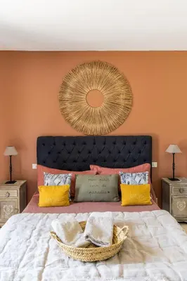 a bedroom with a large bed with a large mirror at Maison style mas « le rougadou » in Noves