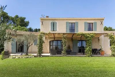an exterior view of a house with a yard at Maison style mas « le rougadou » in Noves