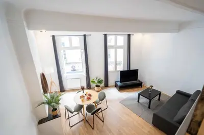 a living room with a table and a couch at Studio Mezzanine Aumône Vieille in Aix-en-Provence