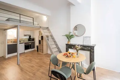 a kitchen and dining room with a table and chairs at Studio Mezzanine Aumône Vieille in Aix-en-Provence