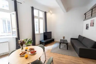 a living room with a table and a couch at Studio Mezzanine Aumône Vieille in Aix-en-Provence