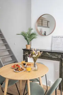a table with a plate of food and a mirror at Studio Mezzanine Aumône Vieille in Aix-en-Provence