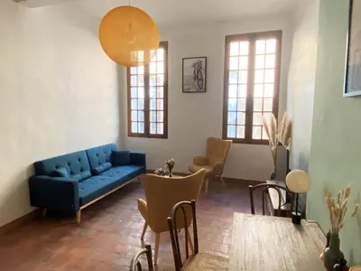 a living room with a blue couch and chairs at Studio Mezzanine Mairie in Aix-en-Provence