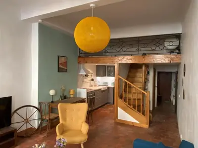 a living room with a table and a yellow orb at Studio Mezzanine Mairie in Aix-en-Provence