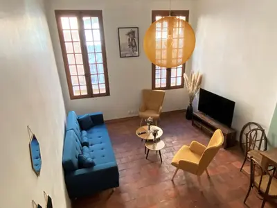 a living room with a blue couch and chairs at Studio Mezzanine Mairie in Aix-en-Provence