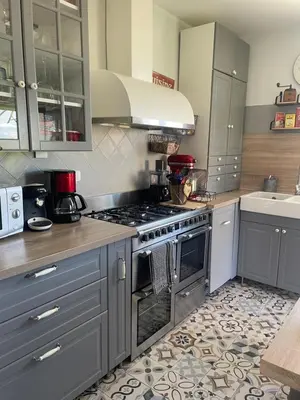 a kitchen with a stainless steel stove top oven at Appartement avec jardin en ville in LʼIsle-sur-la-Sorgue