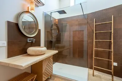 a bathroom with a shower and a mirror at La Fontaine aux Fées in Lagnes