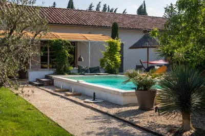 a swimming pool in the backyard of a house at La case d'Eyragues, au coeur des Alpilles in Eyragues