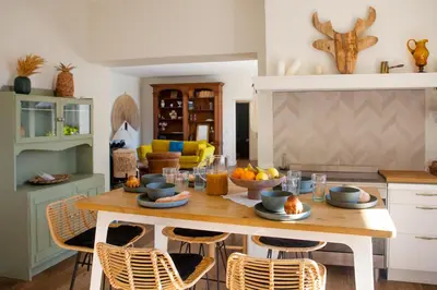 a kitchen with a wooden table with fruit on it at La case d'Eyragues, au coeur des Alpilles in Eyragues