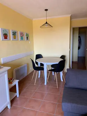 a small kitchen with a couch and a microwave at Appartement domaine du golf Pont Royal Provence avec PARC AQUATIQUE in Mallemort