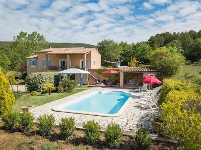 a villa with a swimming pool and a house at Le Mas du Miel d'Or, 12 pers, au coeur du Luberon, air-conditionné, piscine, propriété de 5000 m2 in Villars