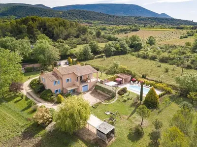 an aerial view of a house in a field at Le Mas du Miel d'Or, 12 pers, au coeur du Luberon, air-conditionné, piscine, propriété de 5000 m2 in Villars