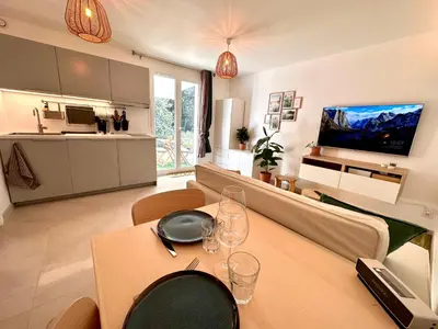a living room with a table with wine glasses on it at Paisible studio tout neuf en lisière de forêt in Peyrolles-en-Provence
