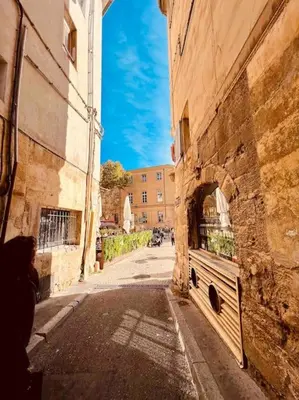 an alley in an old building with an archway on it at Au cœur d’Aix-en-Provence in Aix-en-Provence