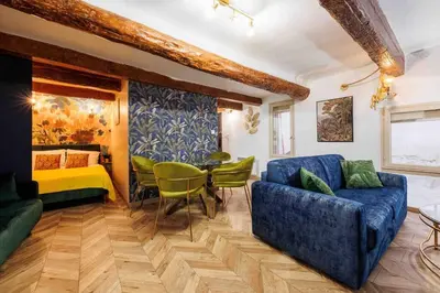 a living room with a couch and a table at Au cœur d’Aix-en-Provence in Aix-en-Provence