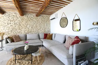 a living room with a couch and a table at Superbe Mas contemporain au pied du Luberon in Cheval-Blanc