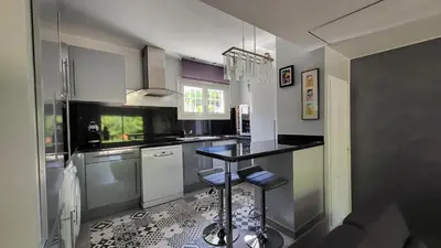 a kitchen with a counter and a table in it at La Tissonnière Oasis d Exception entre Mer Alpilles et Luberon Spa et Piscine à 10 min d Aix en Provence in Saint-Estève-Janson