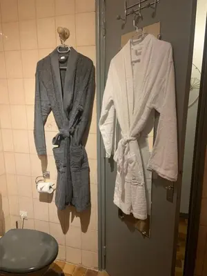 two jackets hanging on a wall in a bathroom at Studio de Luxe Aix en Provence in Aix-en-Provence